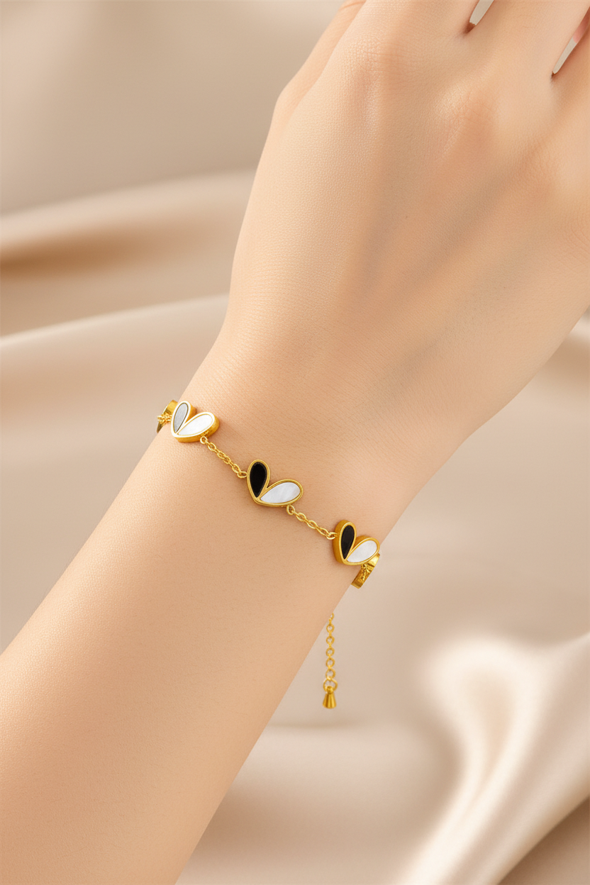 Model wearing black and white shell petal gold bracelet