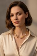 Model wearing gold paperclip pearl necklace