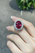 Model wearing ruby red halo cocktail ring